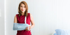 Asian female patient with her arm in a sling