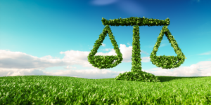 3d rendering of legal scale icon on fresh spring meadow with blue sky in background.