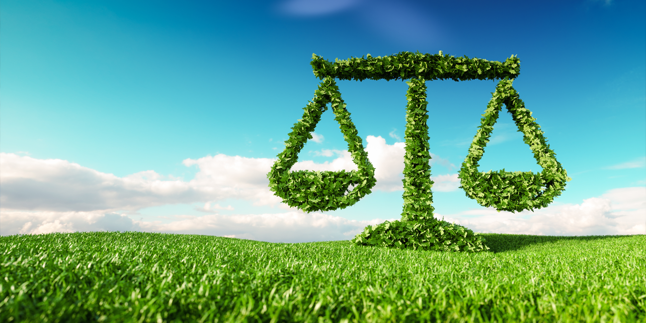 3d rendering of legal scale icon on fresh spring meadow with blue sky in background.